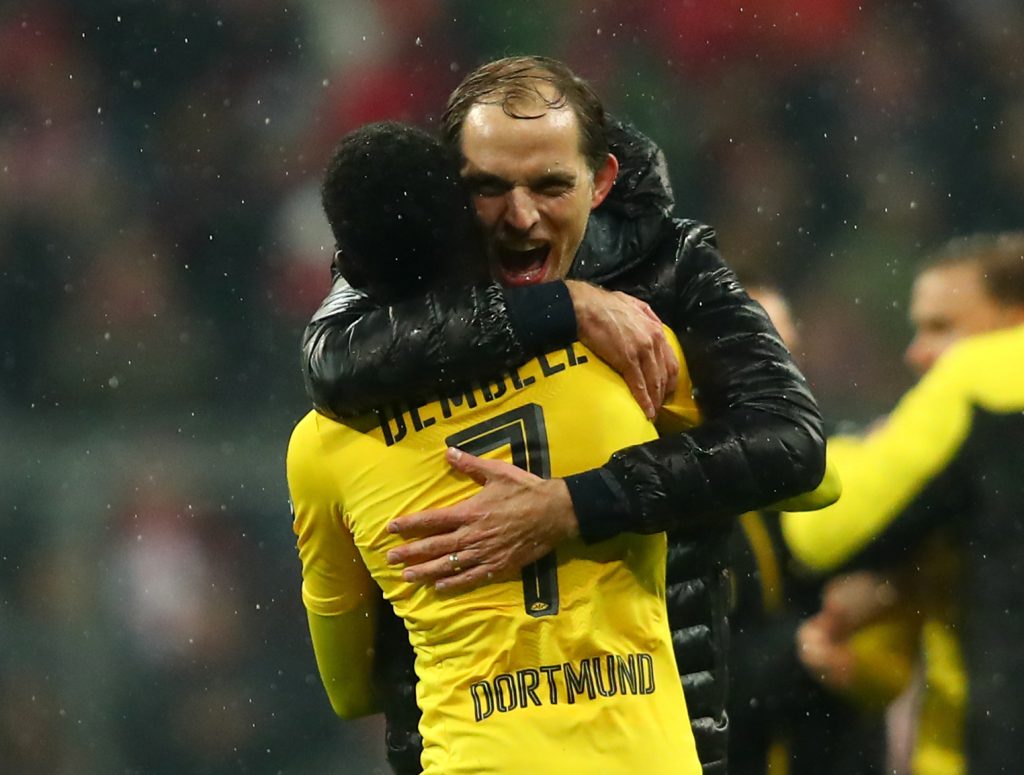 Borussia Dortmund coach Thomas Tuchel and Ousmane Dembele celebrate after the match.
