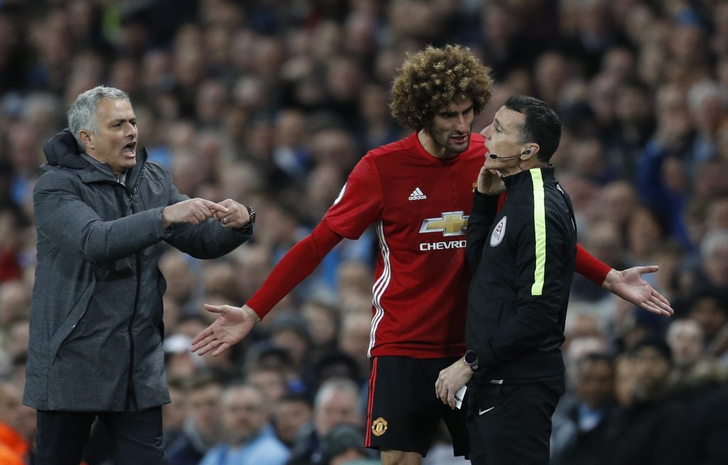 Manchester United's Marouane Fellaini after being sent off with manager Jose Mourinho and fourth official Neil Swarbrick.