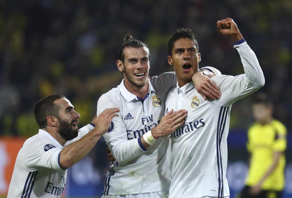 Real Madrid's Raphael Varane reacts with Gareth Bale and Dani Carvajal.