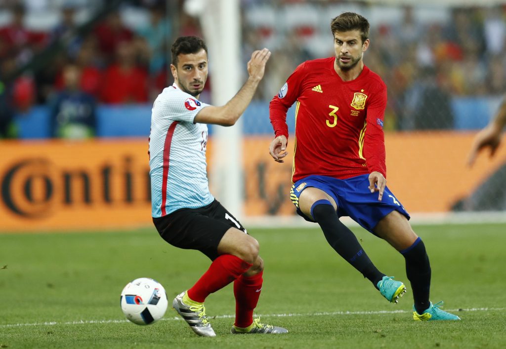 Spain's Gerard Pique in action with Turkey's Oguzhan Ozyakup.