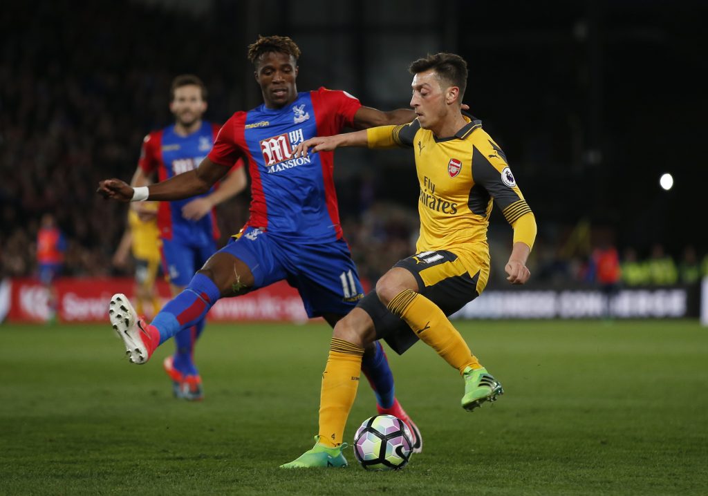 Crystal Palace's Wilfried Zaha in action with Arsenal's Mesut Ozil.