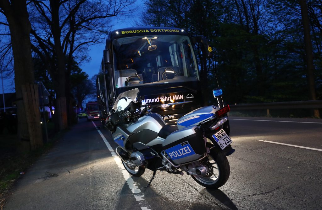 A Police motorcylce with the Borussia Dortmund team bus.