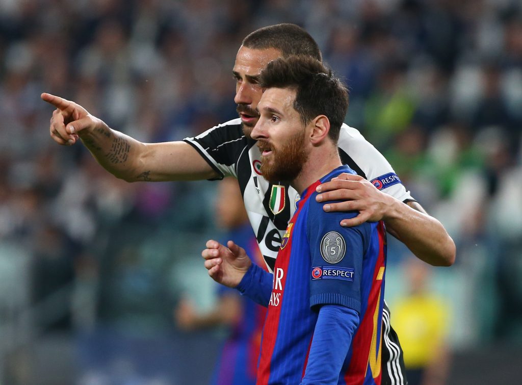 Juventus' Leonardo Bonucci speaks to Barcelona's Lionel Messi.