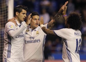 James Rodriguez (C) celebrates a goal with team mate Alvaro Morata (L) and Marcelo.