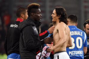 Nice's Mario Balotelli (L) and PSG's Edinson Cavani speak after match.