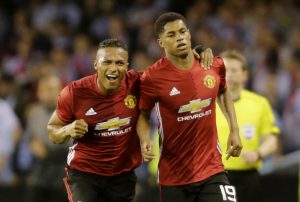 Manchester United's Marcus Rashford celebrates scoring their first goal with Antonio Valencia.