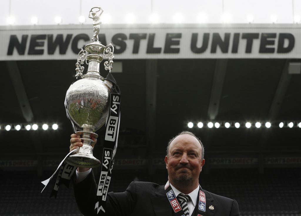 Newcastle manager Rafael Benitez celebrates winning the league with the trophy.