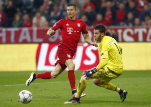 Bayern Munich's Robert Lewandowski in action with Benfica's goalkeeper Ederson.