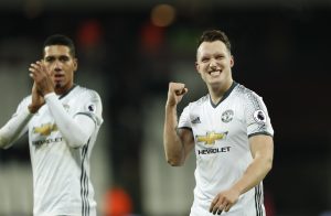 Manchester United's Phil Jones and Chris Smalling (L) celebrate after the game.
