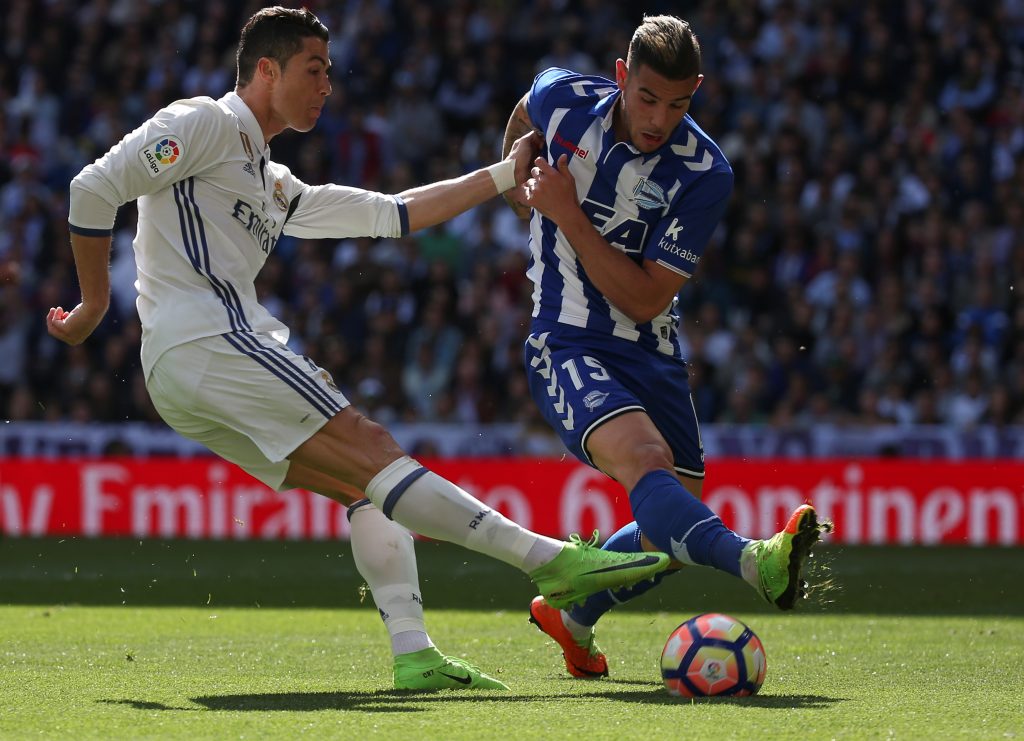 Real Madrid's Cristiano Ronaldo (L) and Alaves' Theo Hernandez in action.