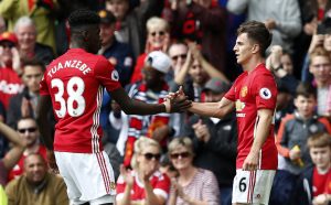 Manchester United's Josh Harrop celebrates scoring their first goal with Axel Tuanzebe.