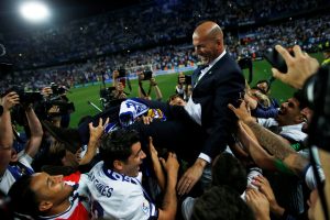 Real Madrid coach Zinedine Zidane is carried by his players as they celebrate winning La Liga.