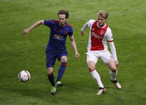 Manchester United's Daley Blind in action with Ajax's Kasper Dolberg.