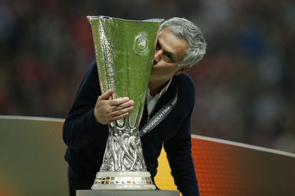 Manchester United manager Jose Mourinho celebrates winning the Europa League with the trophy.