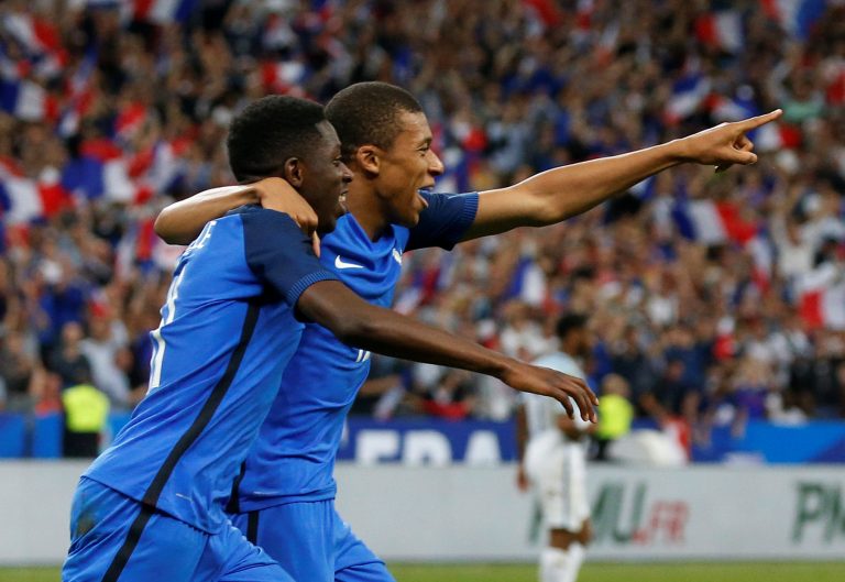 France's Ousmane Dembele celebrates scoring their third goal with Kylian Mbappe.