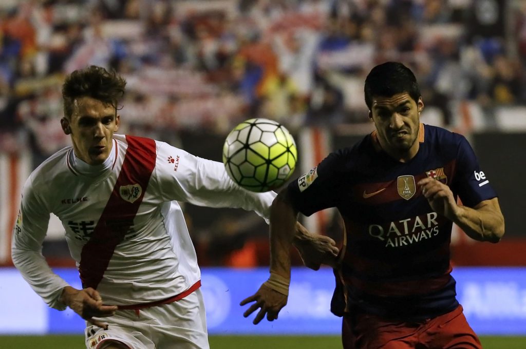 Barcelona's Luis Suarez (R) and Rayo Vallecano's Diego Llorente in action.