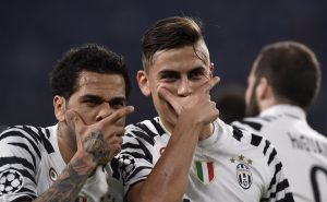 Juventus' Paulo Dybala celebrates scoring their first goal with Dani Alves.