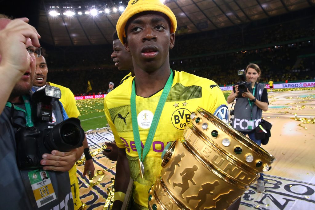 Borussia Dortmund's Ousmane Dembele celebrates with the trophy.
