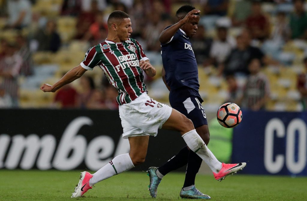 Richarlison of Fluminense and Gustavo Cortez of Universidad Catolica in action.