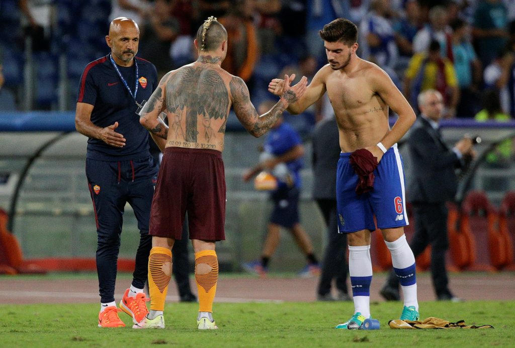 AS Roma's Radja Nainggolan (C) shakes hands with FC Porto's Ruben Neves at the end of the match.