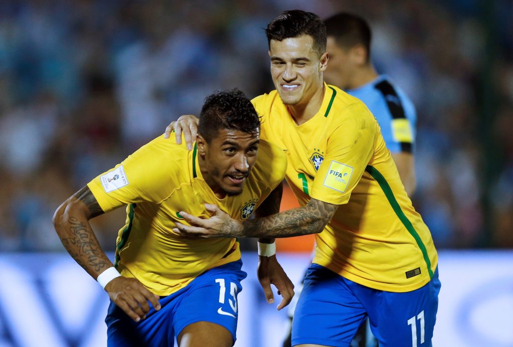 Brazil's Paulinho (L) celebrates his second goal with teammate Phillipe Coutinho.