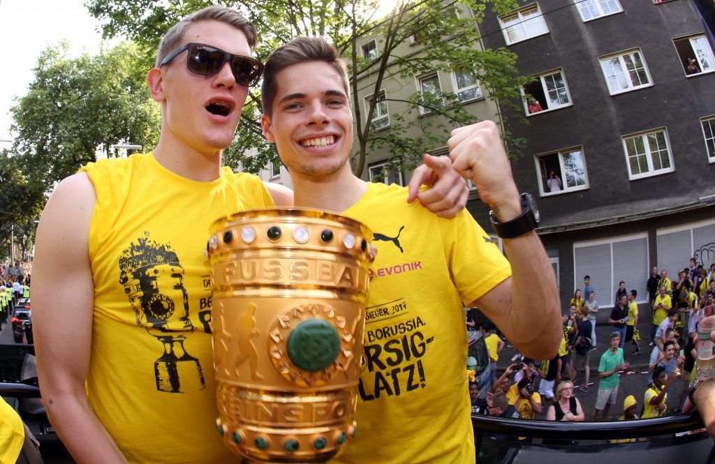 Matthias Ginter (l) and Julian Weigl of Borussia Dortmund celebrate their German Soccer Cup Final victory.