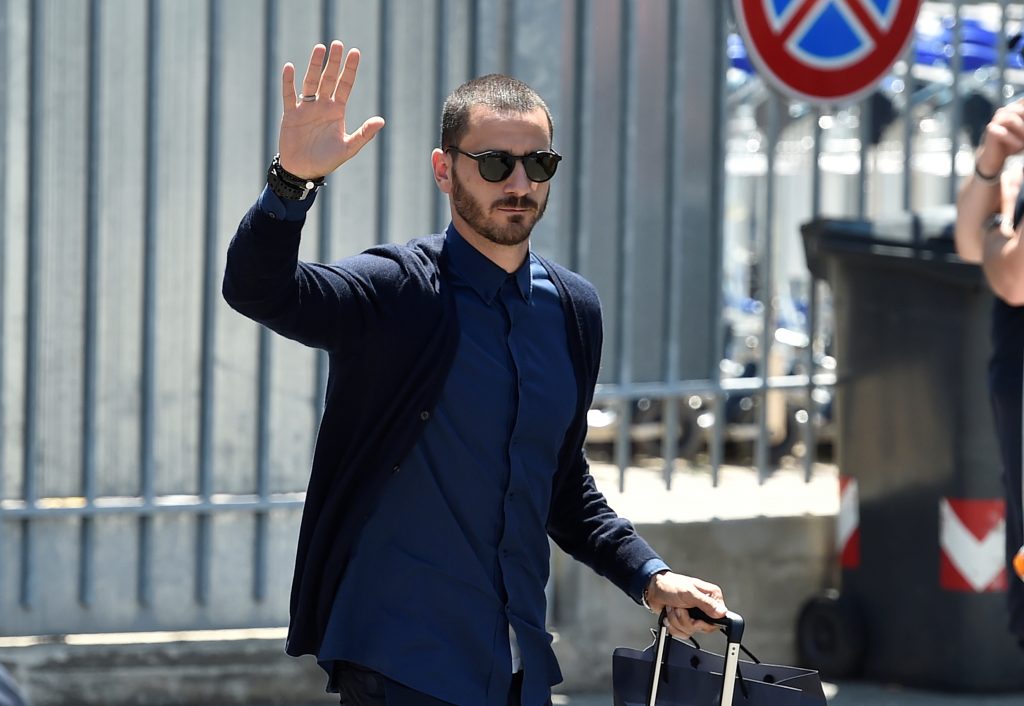 Leonardo Bonucci waves as he arrives at the Caselle airport in Turin, Italy.