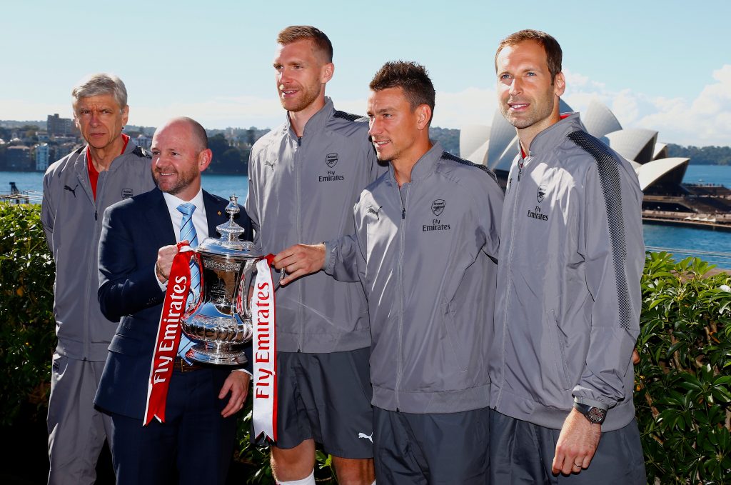 Per Mertesacker, Laurent Koscielny and Peter Czech from English Premier League club Arsenal stand together with team manager Arsene Wenger and New South Wales Minister for Trade and Industry Niall Blair.