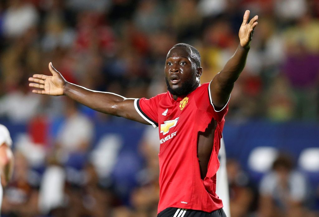 Manchester United's Romelu Lukaku gestures after his shirt is ripped.
