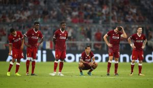 Liverpool players look dejected during the penalty shootout.