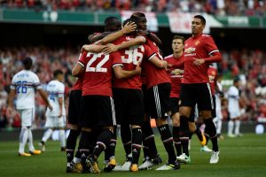 Manchester United's Henrikh Mkhitaryan celebrates scoring their first goal with team mates.