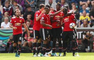 Manchester United's Eric Bailly celebrates scoring their first goal with team mates.