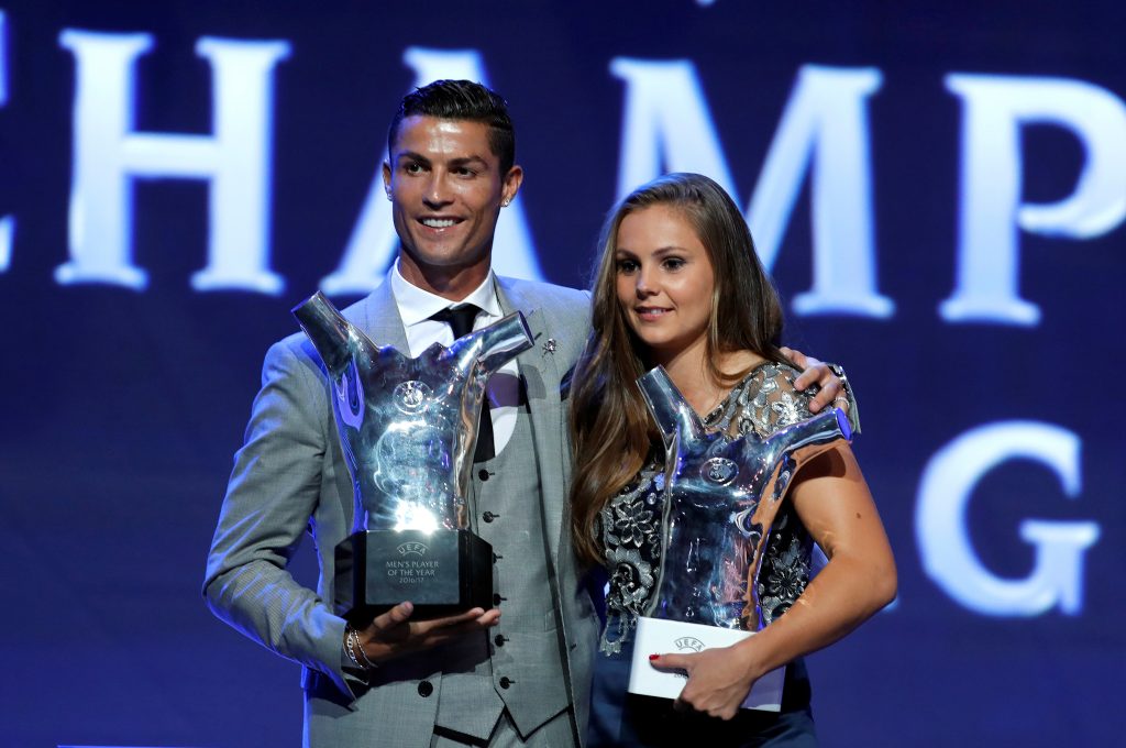 Real Madrid's Cristiano Ronaldo and Barcelona's Lieke Martens hold their trophies.