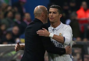 Cristiano Ronaldo and Real Madrid coach Zinedine Zidane hug.