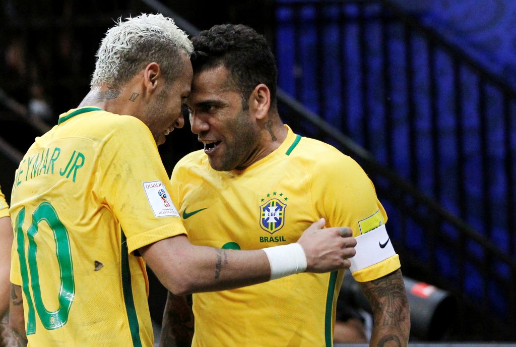 Neymar (L) of Brazil celebrates with team mate Dani Alves after scoring a goal against Colombia.