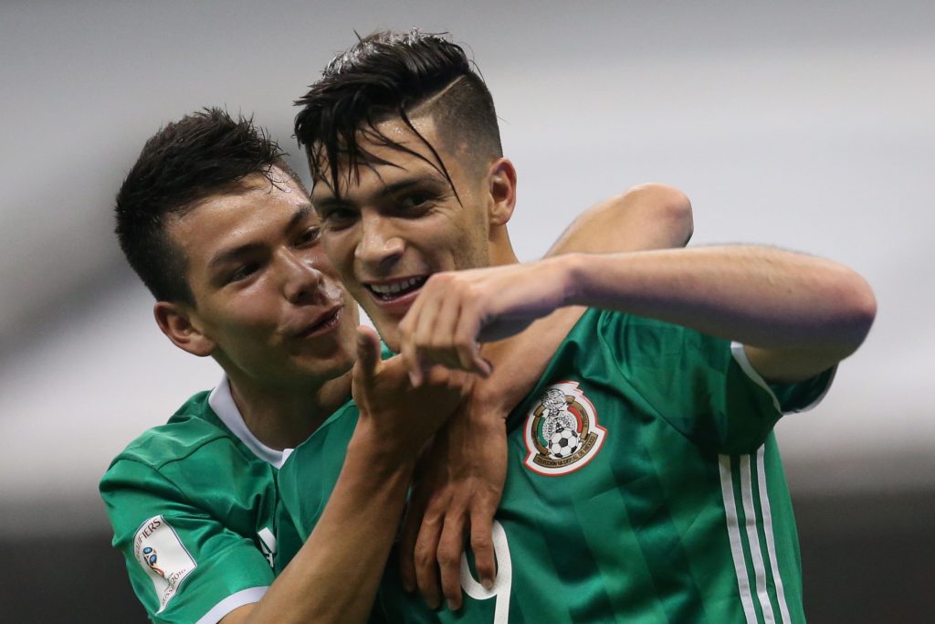 Mexico's Raul Jimenez (R) celebrates a goal against Honduras.