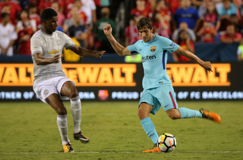 Sergi Roberto in action with Marcus Rashford.