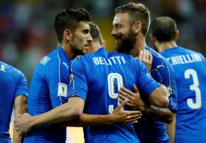 Italy's Andrea Belotti (C) celebrates with team mates Lorenzo Pellegrini (L) and Daniele De Rossi.