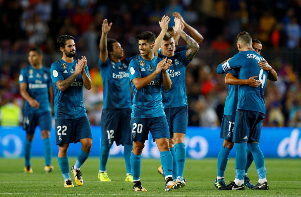 Real Madrids Marco Asensio celebrates with teammates after the match.