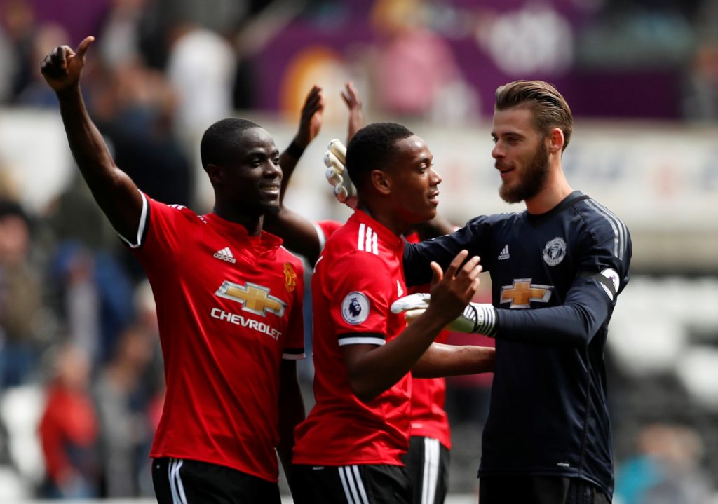 Anthony Martial, Eric Bailly and David De Gea celebrate at the end of the match.