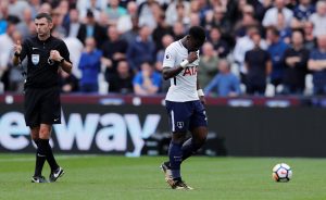 Tottenham's Serge Aurier looks dejected after being sent off.