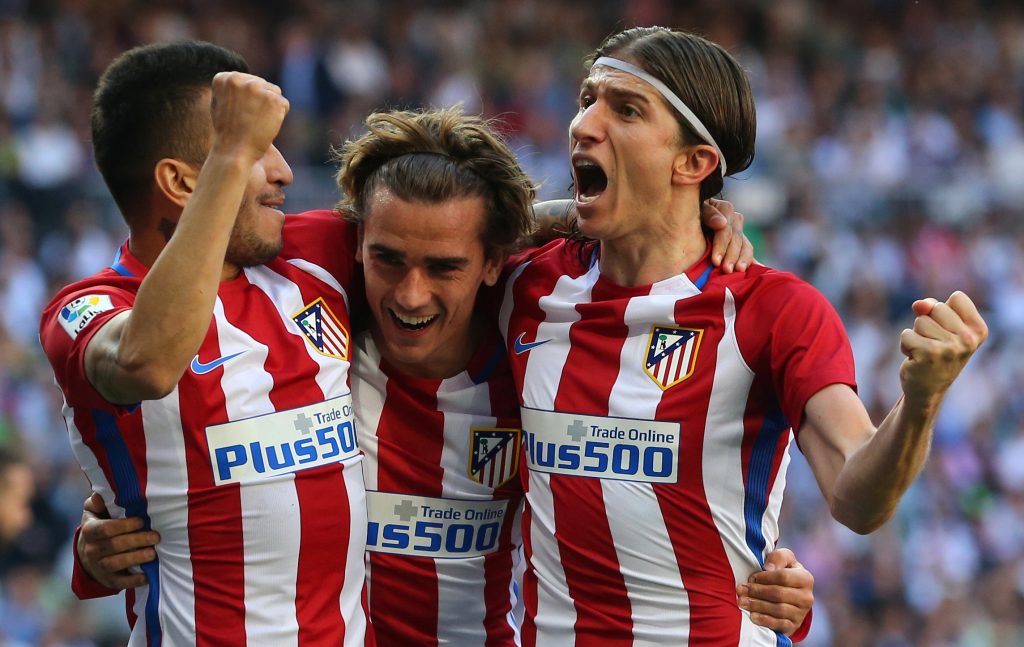 Atletico Madrid's Antoine Griezmann (C) celebrates his goal with his teammates Angel Correa (L) and Filipe Luis.