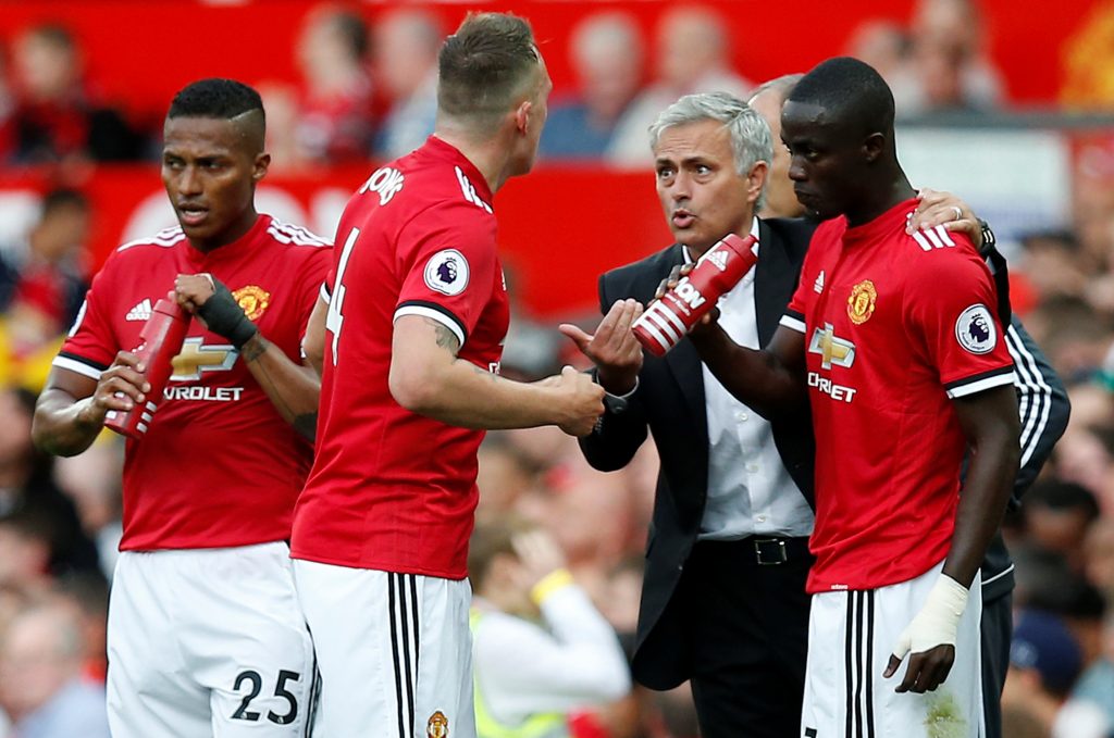 Jose Mourinho speaks with Phil Jones, Eric Bailly and Antonio Valencia.