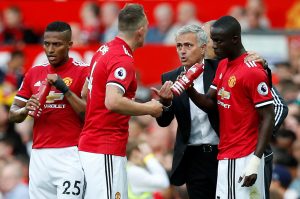 Jose Mourinho speaks with Phil Jones, Eric Bailly and Antonio Valencia.