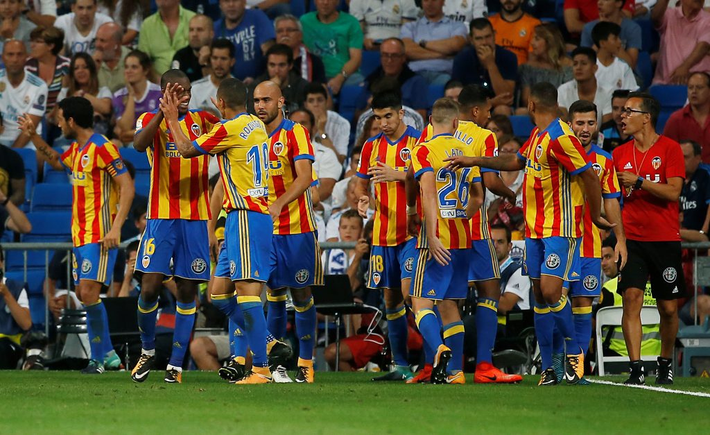 Valencia's Geoffrey Kondogbia celebrates scoring their second goal with teammates.