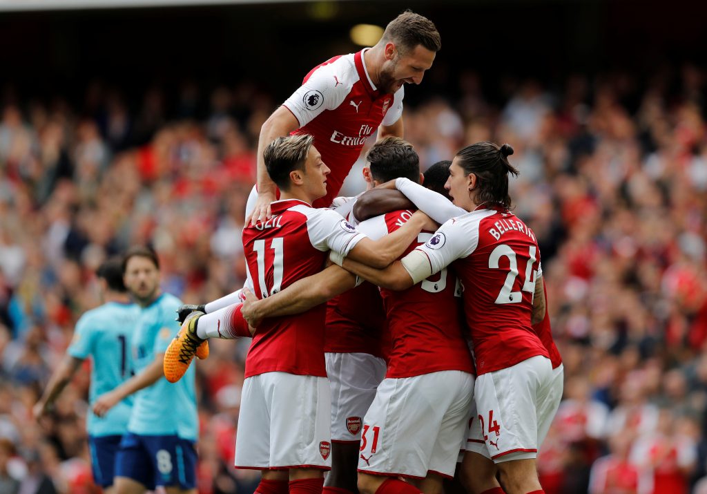 Arsenal's Danny Welbeck (hidden) celebrates scoring their first goal with team mates.