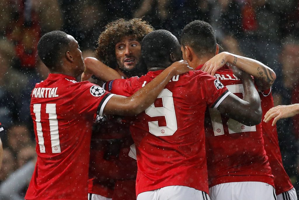Manchester United's Marouane Fellaini celebrates scoring their first goal with teammates.