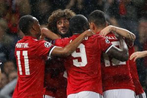 Manchester United's Marouane Fellaini celebrates scoring their first goal with teammates.