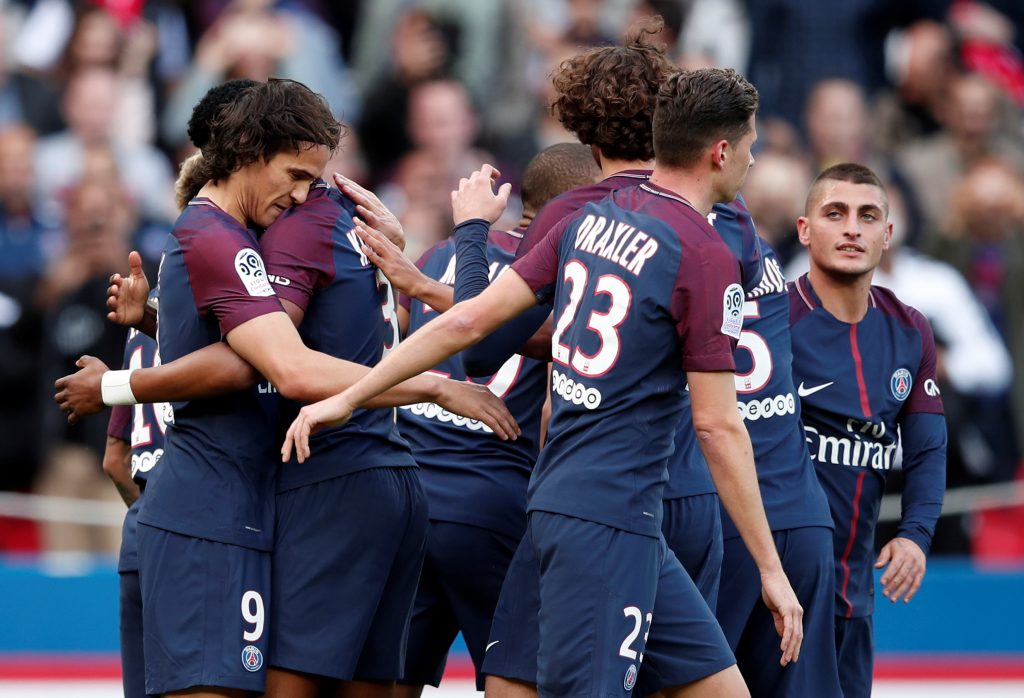 Paris Saint-Germains Edinson Cavani celebrates scoring their second goal with team mates.