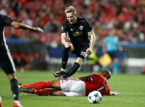 Benfica's Luisao fouls Manchester United's Scott McTominay leading to a second yellow card and red card.